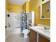 Bright bathroom featuring a tub, shower, floral shower curtain, and vanity at 224 Castle Dr. # 1408, Myrtle Beach, SC 29579