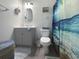 Charming bathroom with gray vanity, toilet, decorative coastal accents, and ocean themed shower curtain at 224 Castle Dr. # 1408, Myrtle Beach, SC 29579