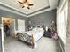 Cozy bedroom showcasing carpeted floors, neutral walls, a tray ceiling, and plenty of natural light at 224 Castle Dr. # 1408, Myrtle Beach, SC 29579