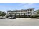 Attractive condo building exterior with manicured landscaping and parking at 224 Castle Dr. # 1408, Myrtle Beach, SC 29579