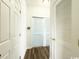 Hallway with wood flooring and closet with white louvered doors at 224 Castle Dr. # 1408, Myrtle Beach, SC 29579