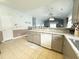 Open-concept kitchen featuring tile flooring, neutral cabinetry, and stainless steel appliances at 224 Castle Dr. # 1408, Myrtle Beach, SC 29579