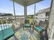 Relaxing screened-in patio offers a comfortable seating area with views of the lush surroundings and pool at 224 Castle Dr. # 1408, Myrtle Beach, SC 29579