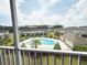 Scenic screened-in patio offers a glimpse of the community pool and lush landscaping at 224 Castle Dr. # 1408, Myrtle Beach, SC 29579