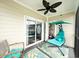 Cozy porch area with a unique swing chair, ceiling fan and sliding glass doors for indoor/outdoor living at 224 Castle Dr. # 1408, Myrtle Beach, SC 29579