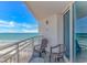 Relaxing balcony with ocean views, two chairs, and a table, perfect for enjoying coastal breezes at 2301 S Ocean Blvd. # 1202, North Myrtle Beach, SC 29582