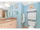 Bright bathroom with granite countertop vanity, decorative beach themed artwork, and ample storage at 2301 S Ocean Blvd. # 1202, North Myrtle Beach, SC 29582