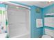 Bright blue bathroom featuring a shower and beach-themed decor at 2301 S Ocean Blvd. # 1202, North Myrtle Beach, SC 29582