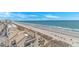 Picturesque beachfront scene featuring a sandy shoreline, ocean waves, and a row of condos at 2301 S Ocean Blvd. # 1202, North Myrtle Beach, SC 29582