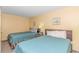 Cozy bedroom featuring two comfortable beds, complemented by soft lighting and stylish decor at 2301 S Ocean Blvd. # 1202, North Myrtle Beach, SC 29582