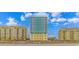 A modern condo building on a sunny day with blue sky and puffy clouds at 2301 S Ocean Blvd. # 1202, North Myrtle Beach, SC 29582