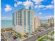 Beautiful exterior view of a beachfront resort with parking and scenic ocean views on a bright, sunny day at 2301 S Ocean Blvd. # 1202, North Myrtle Beach, SC 29582