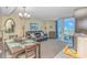 Cozy living room with dining area, comfortable seating, and a sliding glass door to a balcony with beautiful views at 2301 S Ocean Blvd. # 1202, North Myrtle Beach, SC 29582