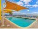 Outdoor pool area with comfortable lounge chairs, colorful umbrellas, and clear blue water at 2301 S Ocean Blvd. # 1202, North Myrtle Beach, SC 29582