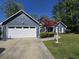 Exterior view featuring a spacious white garage door, concrete driveway and well-maintained lawn and garden at 2333 Brick Dr., Longs, SC 29568