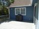 Backyard deck featuring an outdoor grill, adjacent to the home's blue siding and manicured lawn at 2333 Brick Dr., Longs, SC 29568