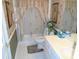 Well-lit bathroom featuring white tile floors, neutral wallpaper, and palm tree shower curtain at 2333 Brick Dr., Longs, SC 29568