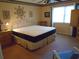 Bedroom features large bed, carpeted floor, and accent decorations on the yellow wall at 2333 Brick Dr., Longs, SC 29568