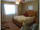 Bedroom featuring a wood bed frame, tropical patterned wallpaper, and natural light from a window at 2333 Brick Dr., Longs, SC 29568