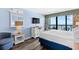 Comfortable bedroom with TV, dresser, and a view of the ocean from the window at 2401 S Ocean Blvd. # 752, Myrtle Beach, SC 29577
