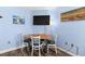Dining space with a wooden table, four chairs, and a mounted flat screen TV on the wall at 2401 S Ocean Blvd. # 752, Myrtle Beach, SC 29577