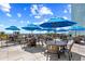 Inviting outdoor dining space with tables, chairs, blue umbrellas, and beautiful ocean views at 2401 S Ocean Blvd. # 752, Myrtle Beach, SC 29577