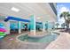 Unique outdoor water feature with seating, colorful murals, and tropical palm trees at 2401 S Ocean Blvd. # 752, Myrtle Beach, SC 29577
