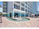 Relaxing outdoor water feature with steps for easy access, lounge chairs, and building architecture at 2401 S Ocean Blvd. # 752, Myrtle Beach, SC 29577