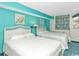 Comfortable bedroom with bright blue walls and two beds at 2801 S Ocean Blvd. # 339, North Myrtle Beach, SC 29582