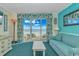 Bright living room with a sofa, coffee table, and ocean view from the balcony at 2801 S Ocean Blvd. # 339, North Myrtle Beach, SC 29582