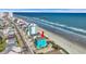 Aerial view of a teal beach house near the ocean with a pier in the background at 2808 N Ocean Blvd., North Myrtle Beach, SC 29582