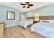 Bright bedroom showcasing two beds, mirror, side table, light blue walls, and wood floors at 2808 N Ocean Blvd., North Myrtle Beach, SC 29582