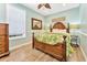 Well-lit bedroom featuring a wooden bed frame, tropical quilt, and beautiful natural light at 2808 N Ocean Blvd., North Myrtle Beach, SC 29582