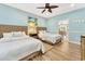 A charming bedroom with two beds, light blue walls, wood floors and ceiling fan at 2808 N Ocean Blvd., North Myrtle Beach, SC 29582