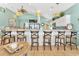 Bright kitchen with a long bar with stools and stainless steel appliances at 2808 N Ocean Blvd., North Myrtle Beach, SC 29582