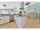 Kitchen island with cooktop, adjacent dishwasher, cabinets, and living area beyond at 2808 N Ocean Blvd., North Myrtle Beach, SC 29582