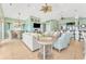 Open-concept living room with lots of natural light, high ceilings, and ceiling fans at 2808 N Ocean Blvd., North Myrtle Beach, SC 29582