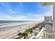 Gorgeous ocean views from a balcony with white chairs and railings, a real seaside retreat at 2808 N Ocean Blvd., North Myrtle Beach, SC 29582