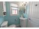 Bright bathroom featuring blue walls, a white vanity, and a stylish mirror and fixtures at 314 45Th Ave. N, North Myrtle Beach, SC 29582