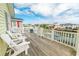 Waterfront deck with white Adirondack chairs, perfect for relaxation and enjoying scenic views at 314 45Th Ave. N, North Myrtle Beach, SC 29582