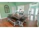 Dining area with a large wooden table, bench seating, and open access to the kitchen at 314 45Th Ave. N, North Myrtle Beach, SC 29582