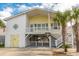 Charming beach house with a white and yellow exterior, a front deck and ample parking at 314 45Th Ave. N, North Myrtle Beach, SC 29582