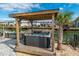 Inviting outdoor hot tub with a pergola providing shade and privacy at 314 45Th Ave. N, North Myrtle Beach, SC 29582