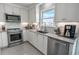 Well-appointed kitchen featuring stainless appliances, white cabinets, and tile backsplash at 314 45Th Ave. N, North Myrtle Beach, SC 29582