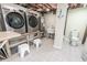 Functional laundry room with modern washer and dryer, sink, and ample storage space, complemented by stylish tiled flooring at 314 45Th Ave. N, North Myrtle Beach, SC 29582