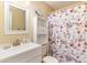 Well-lit bathroom with white vanity, ample storage, and a stylish, themed shower curtain at 3700 Golf Colony Lane # 21 B, Little River, SC 29566
