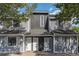 Charming townhouse exterior with gray siding, white doors, and manicured landscaping at 3700 Golf Colony Lane # 21 B, Little River, SC 29566