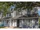 Charming townhouse exterior with gray siding, white doors, and manicured landscaping at 3700 Golf Colony Lane # 21 B, Little River, SC 29566