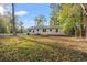 Expansive backyard with lush lawn and mature trees, perfect for outdoor activities at 3934 North Fraser St., Georgetown, SC 29440