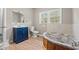 Bright bathroom featuring a modern vanity, soaking tub, and a large window for natural light at 3934 North Fraser St., Georgetown, SC 29440